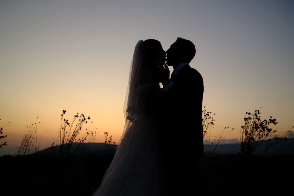 Wedding couple in a sunset landscape